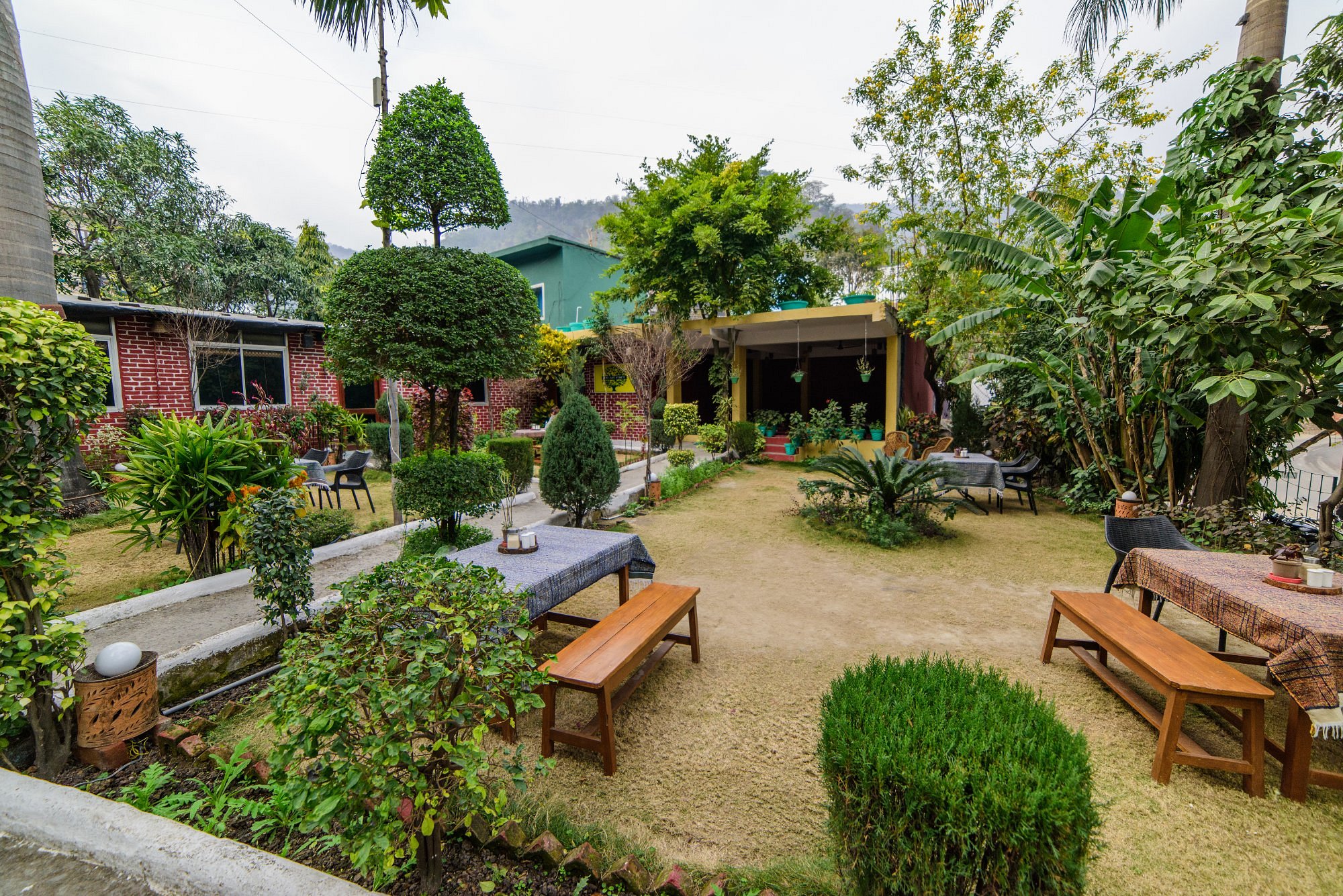 A beautiful resort view of 60's Green Hills Resort in Rishikesh with surrounding mountains and 
trees.